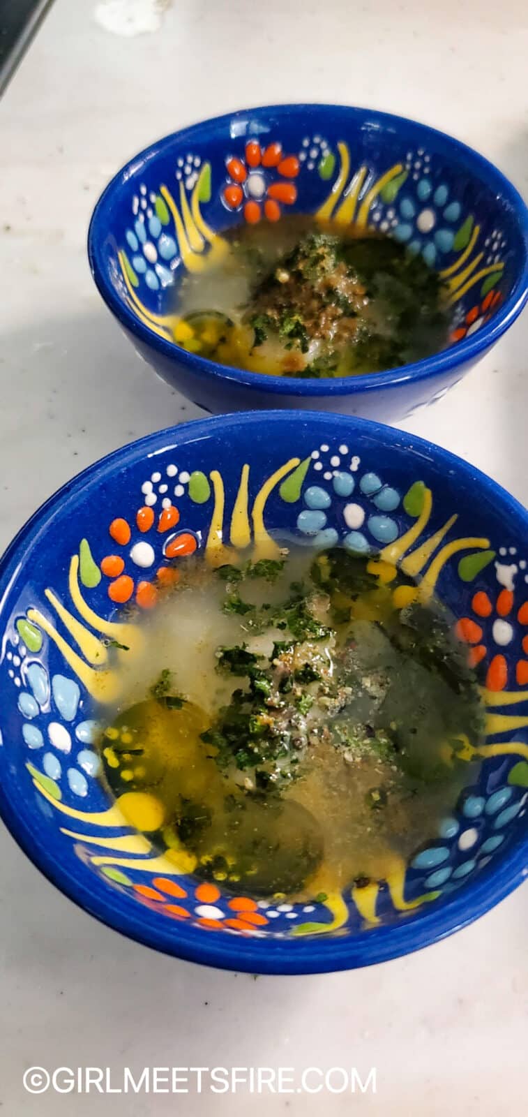 a small blue ceramic bowl with aji-i-mojili